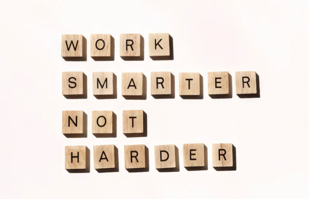 work smarter not harder spelled out in wooden